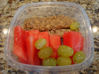 Slices of breakfast cookie, water melon and grapes in clear container