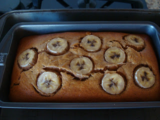 Vegan Peanut Butter Banana Bread in pan topped with sliced bananas