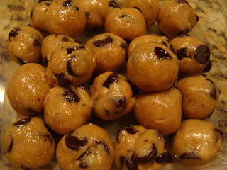 Multiple Raw Vegan Chocolate Chip Cookie Dough Balls stacked on top of each other 
