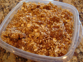 Raw Vegan Apple Crumble in clear container on countertop