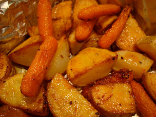 Roasted red and yukon gold potatoes, baby carrots in foil lined pan