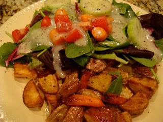 Close up of salad and mixed potatoes and carrots on white plate