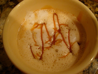 Combined steamed milk and espresso shots in mug drizzled with caramel
