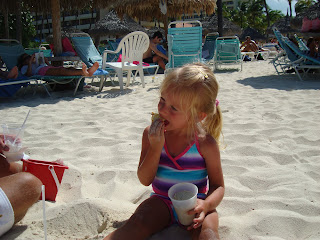Young girl with cup playing on beach