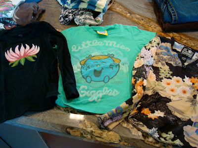 Variety of shirts on countertop
