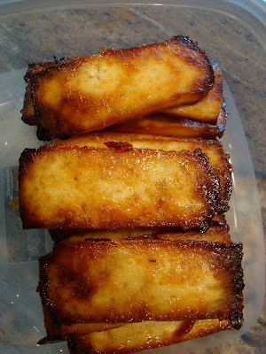 Stacked baked tofu in clear container