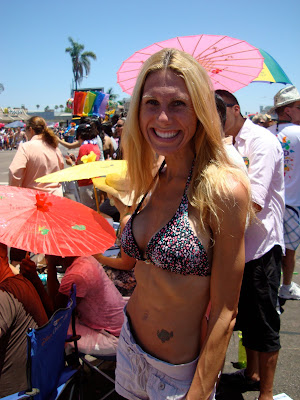 Woman in bikini top at Gay Pride Parade smiling