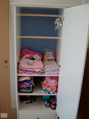Open wardrobe showing shelves and hangers