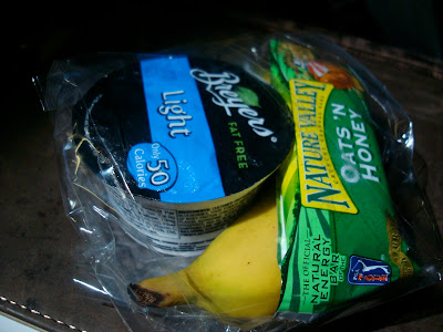 Snack packs of yogurt, banana and granola bar on plane