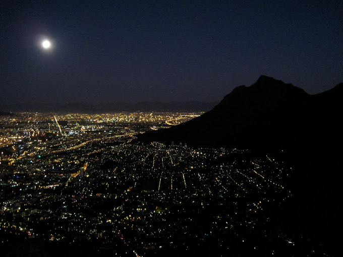 Cape Town at night with the full moon. Devil's peak on the right