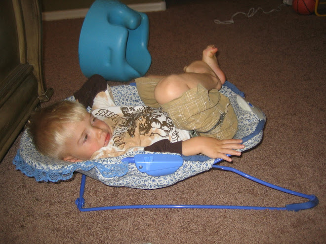 Kolton watching tv in Krews bouncer