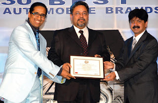 Professor Arindam Chaudhuri (left) and Mr. Adarsh Hedge (right) giving away the award to Mr. Kaushik Roy, President- Brand Strategy & Mktg. Comm. , Reliance Industries (center)