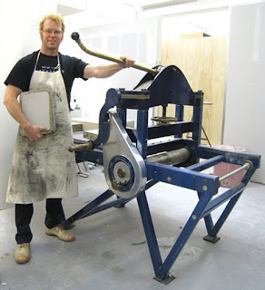 Chair of Faculty and Printmaking coordinator, John Jacobsmeyer stands next to the Griffin Series I lithography press