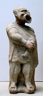 Actor wearing a comic mask. Hellenistic terracotta figurine, 2nd century BC. Photo by Marie-Lan Nguyen (2007)