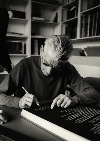 Samuel Beckett at his apartment in Paris signing a rare Limited Edition copy of The Lost Ones