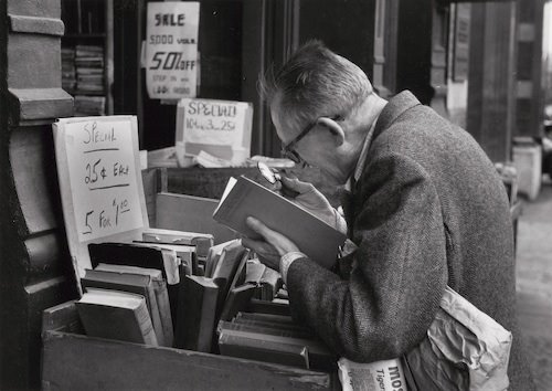 André Kertész: On Reading. Fourth Avenue, New York (man reading at outdoor book stall), June 4, 1959