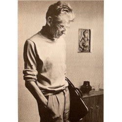 Photograph of Samuel Beckett holding a leather portfolio