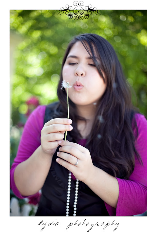 Senior girl blowing a dandelion for American Christian Academy senior lifestyle portraits in Grass Valley, California