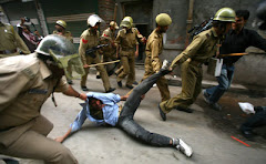 POLICEMEN DRAGGING A PROTESTING YOUTH