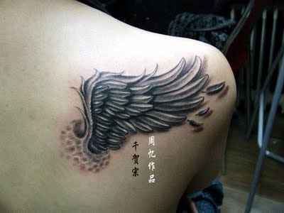 Angel wing tattoo and chinese text tattoo