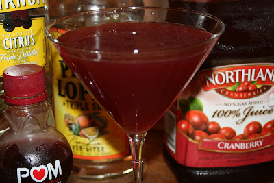 A cosmopolitan adult cocktail made with citrus vodka, triple sec, pomegranate juice, cranberry juice and lime