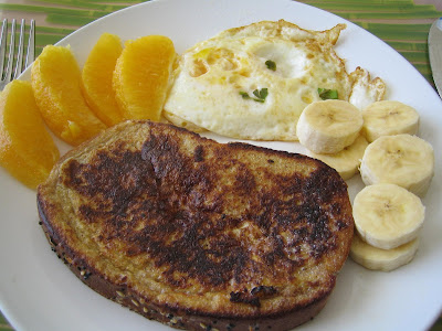 French toast, fried egg, orange wedges, and banana French toast, fried egg, orange wedges, and banana