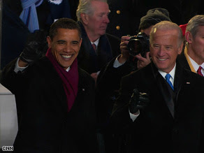 President Barack Obama and Vice President Joe Biden watch the inaugural parade outside the White House.