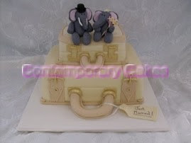 Suitcase stacked cake with sugar paste elephant bride and grooms.