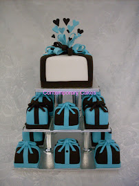 Miniature cakes with a teal blue and chocolate colour scheme.