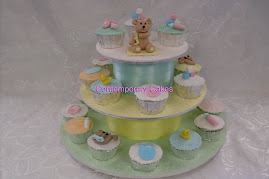 baby shower cupcake tower in a neutral colour scheme.