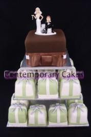 Chocolate sugar paste  covered cutting cake with avocado green, ivory and silver miniature cakes.