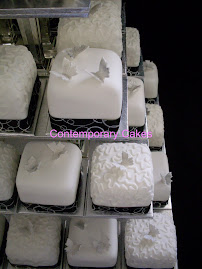 Miniature cakes with piped cornelli design with sugar butterflies.