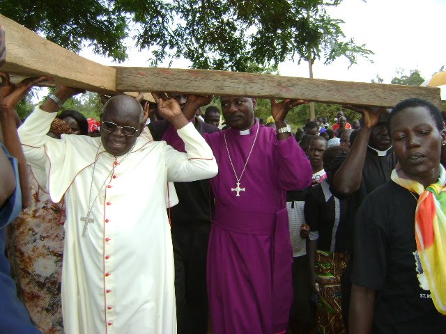 The Archbishop of the Church of Uganda, Luke Orombi, carrying a cross