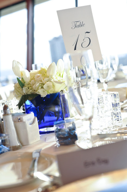 The centerpieces were royal blue square vases with white hydrangea roses 