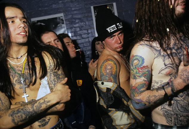 A rock music fanatic having arm dragon tattoo.