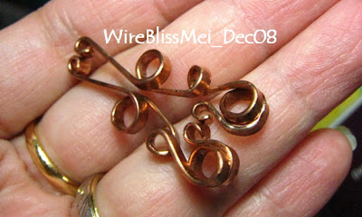 copper wire shaping hammer two copper wires and twisted them into this two almost identical pieces