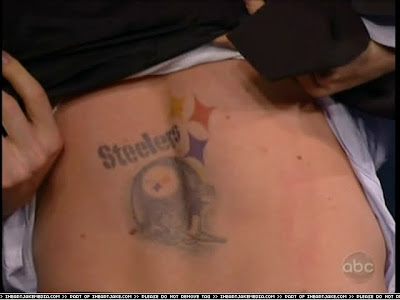 -Jake shows Steelers tattoo on his back and teases to show his merkin.