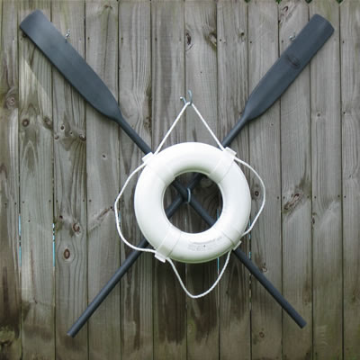 Crossed Oars with Life Buoy, close up Crossed Oars with Life Buoy, close up