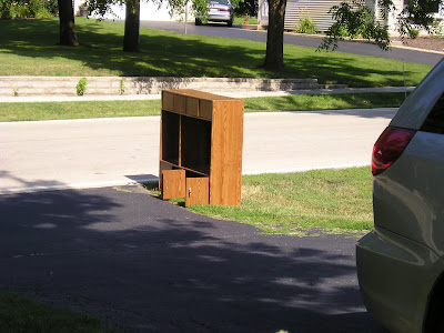 Old oak entertainment center at the curb