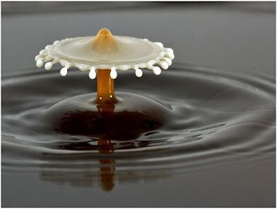 super slow motion picture of cream drops to coffee 11