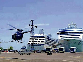 A police helicopter flies over the port of Limon as cruise tourists disembark. (Photo: Mario Carvajal/La Nacion)