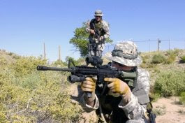 1st Sgt. Jason Riley, of the New Mexico National Guard's Combat Arms Training Company, takes up a firing position on a live-fire obstacle course during training in the New Mexico National Guard's gunfighter course near Albuquerque, N.M., May 30. (Photo by Staff Sgt. Jim Greenhill)