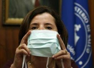 Costa Rica's Minister of Health Maria Luis Avila holds surgical face masks during a news conference in San Jose April 28, 2009. Costa Rica found a
