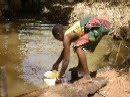 Dipping water from a stream