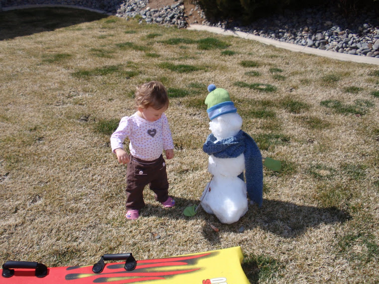 Kyndel playing with snowman the next day