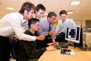 Krishna Palem (second from right) is working with Yeo Kiat Seng (right) and students at the Centre for Integrated Circuits and Systems at Nanyang Technological University in Singapore to develop the first production prototypes of a new type of power-stingy computer chip called PCMOS. NANYANG TECHNOLOGICAL UNIVERISTY