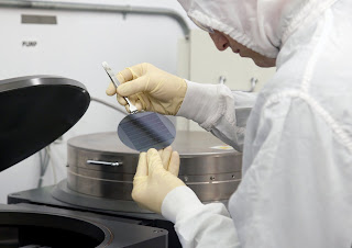 Hawkins removes a wafer containing 49 virus-detecting chips