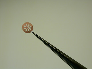 Magnified image of research samples with small holes covered by graphene