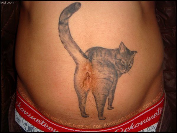 A tattoo lover showing a very funny tattoo design on stomach.