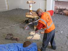 Workers at JPL start digging to replicate Spirit's situation on Mars.